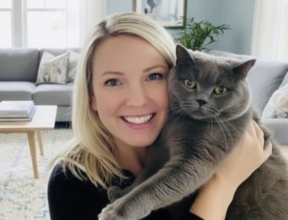 blonde girl holding grey cat